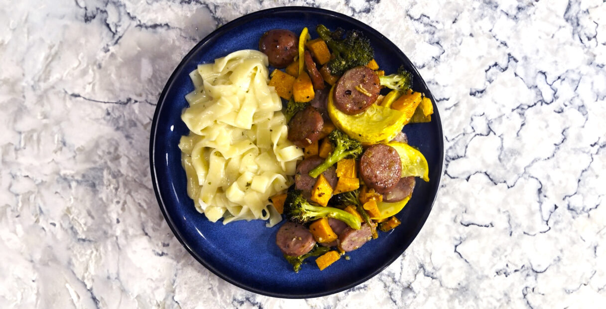 Sheet pan chicken sausage on a blue plate