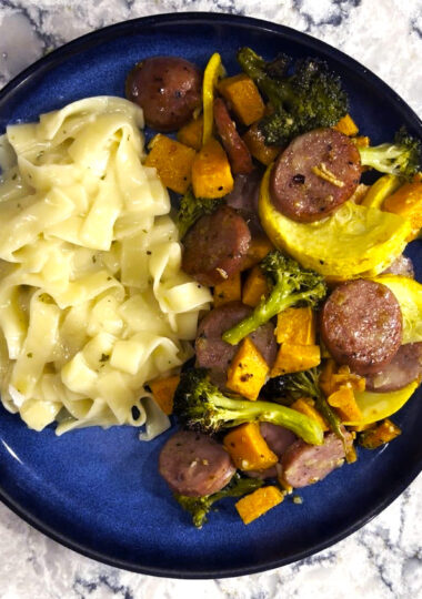 Sheet pan chicken sausage on a blue plate