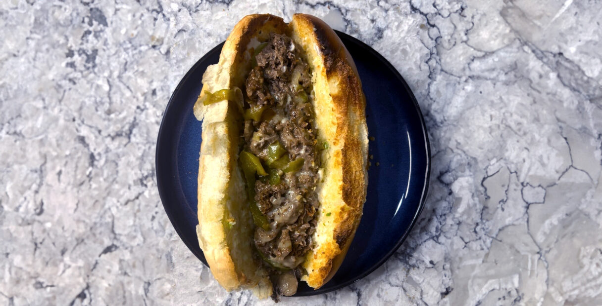 Philly cheese steak on a blue plate