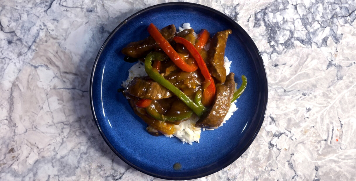 pepper steak on a blue plate